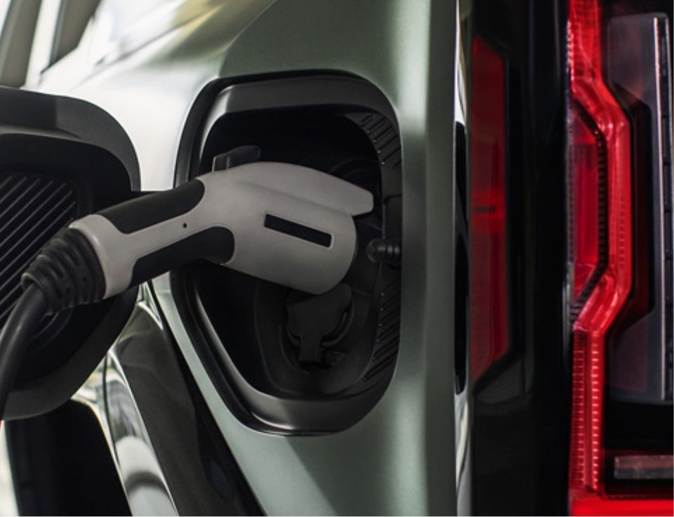Close up of charging port with charger plugged in on a GMC Hummer EV SUV - Cecil GMC of Fredericksburg in FREDERICKSBURG TX